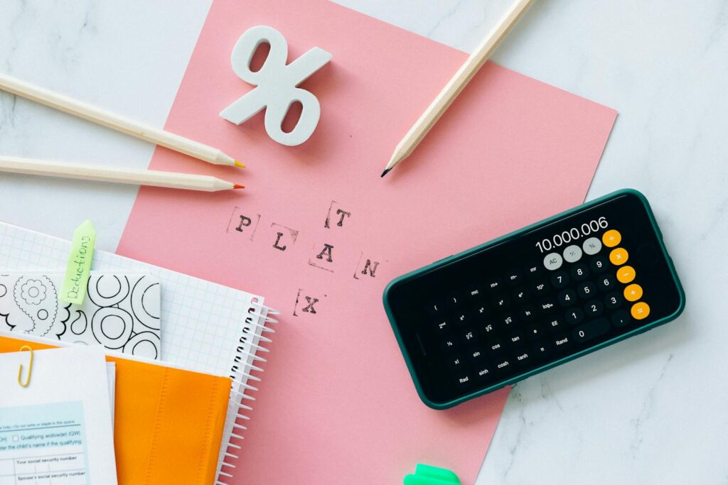 Mastering the Accounting Cycle for Small Business Success 2 Flat lay showing tax planning tools including a calculator, pencils, and stationery items.