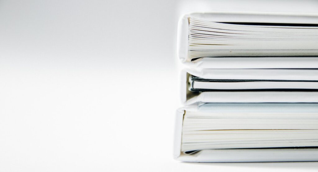Business Brilliance Leveraging Bargaining Power for Success 1 A stack of thick folders on a white surface