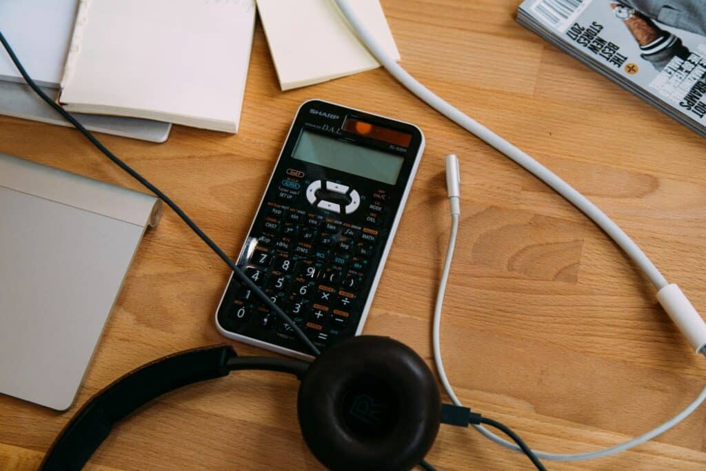 Mastering the Accounting Cycle for Small Business Success 1 black scientific calculator beside black headphones